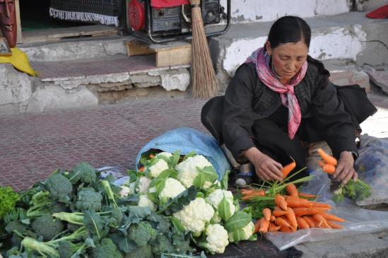 Tibétaine qui vend ses légumes bio sur le trottoir de Leh